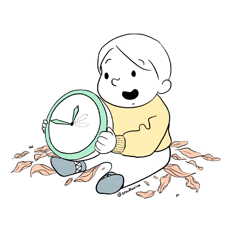 baby playing with a clock