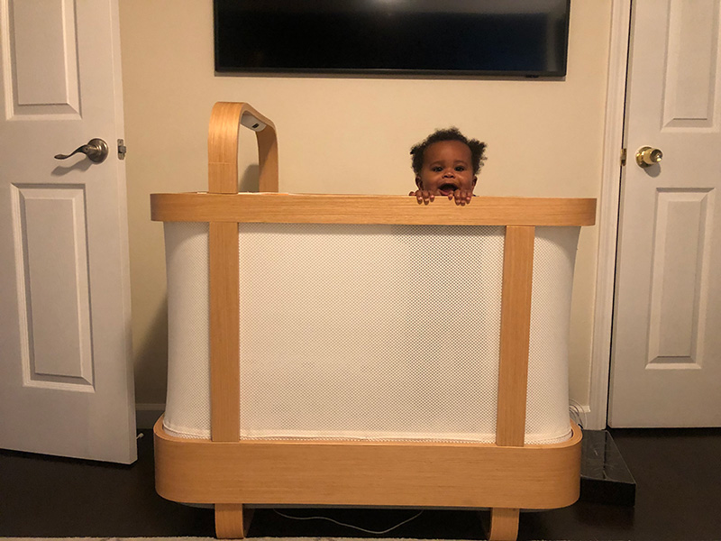 Baby standing in Cradlewise smart crib