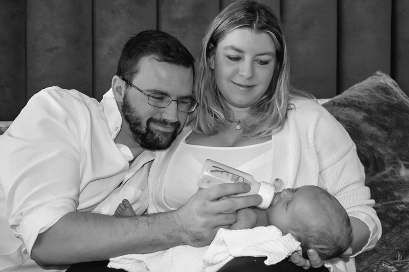 Stacey Haney and her husband Evan Haney feeding their newborn son Armour.